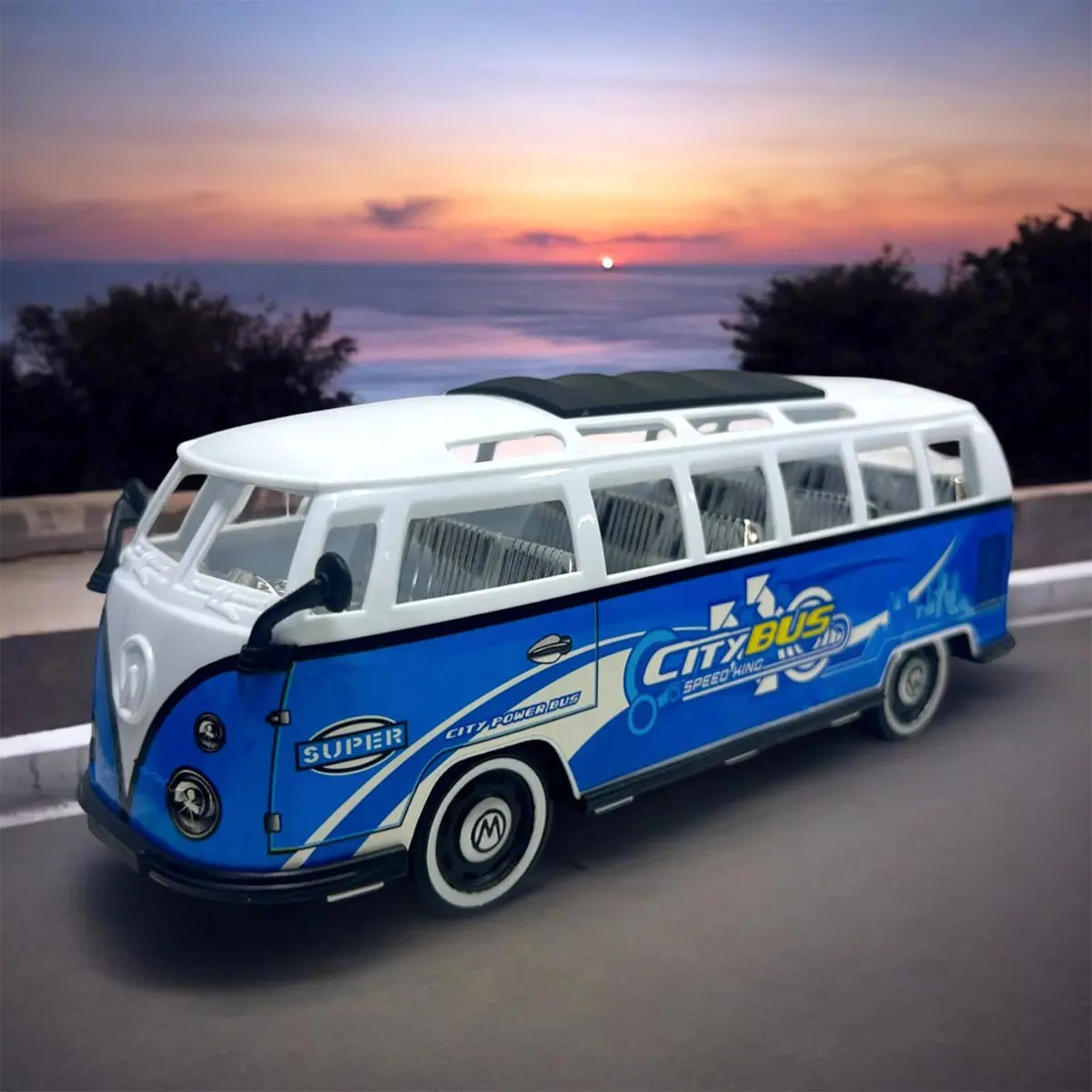 Autobús de juguete azul y blanco sobre fondo de atardecer.