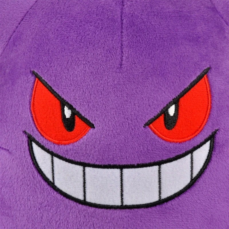 Primer plano del rostro de un peluche Gengar con expresión traviesa.